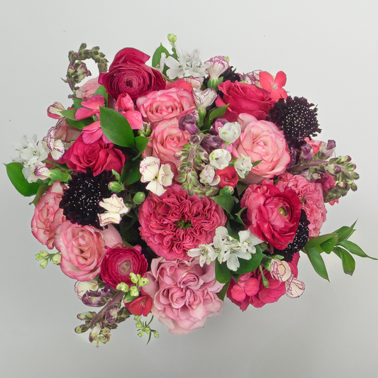 Bouquet of pink and red flowers on a light gray background